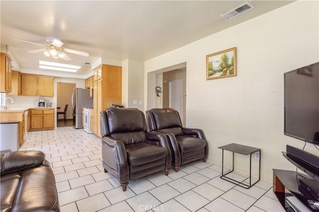 living room with ceiling fan and sink