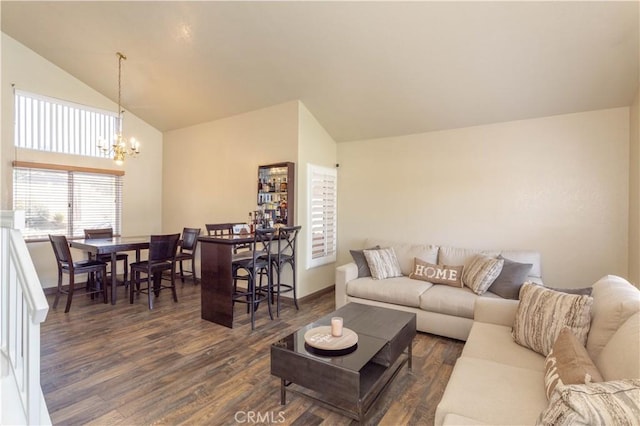 living room with lofted ceiling, dark hardwood / wood-style floors, and a notable chandelier