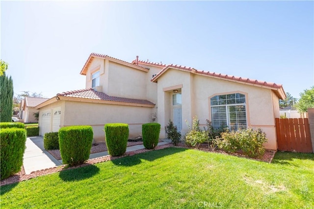 mediterranean / spanish house featuring a garage and a front yard