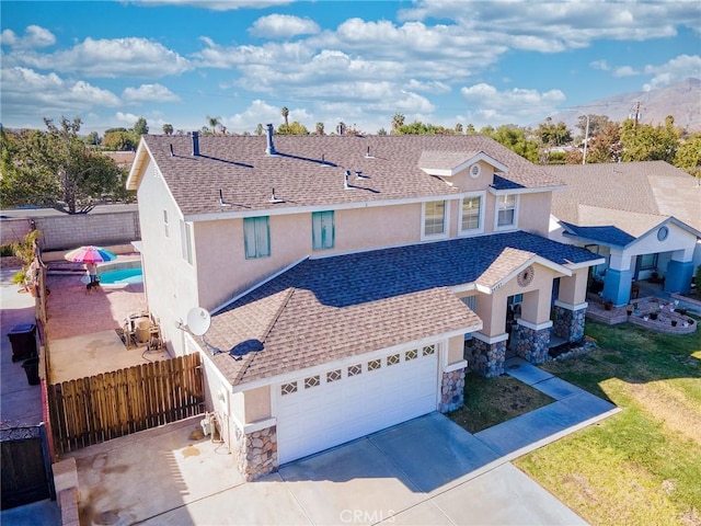 view of front of house with a garage and a fenced in pool