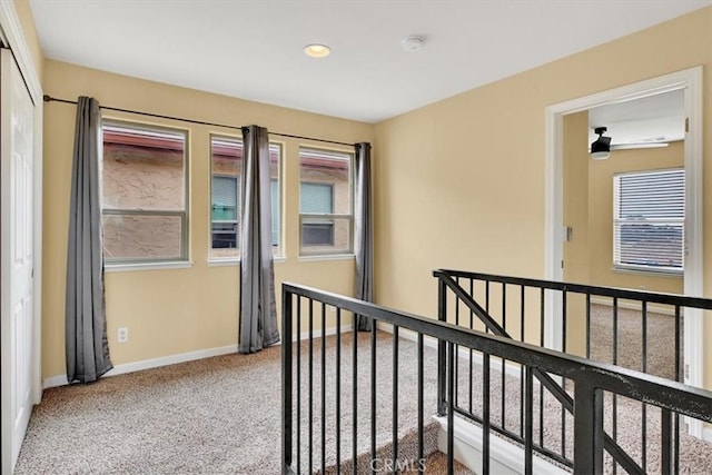 corridor with light colored carpet