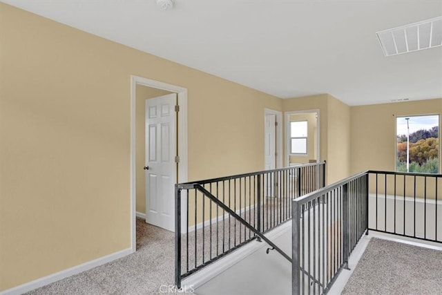 corridor with light colored carpet