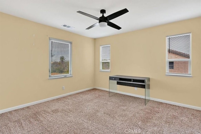 carpeted empty room featuring ceiling fan