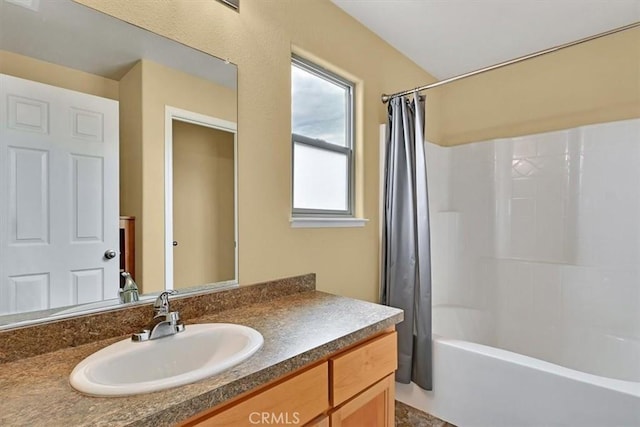 bathroom with vanity and shower / bath combo