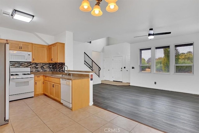 kitchen with light wood-type flooring, white appliances, ceiling fan with notable chandelier, sink, and light brown cabinets