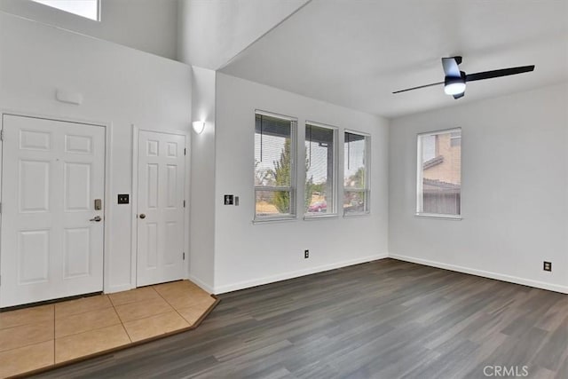 foyer entrance with ceiling fan and wood-type flooring