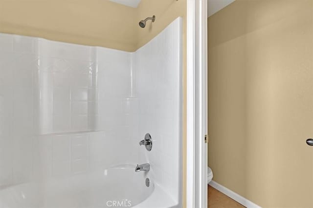 bathroom with shower / tub combination and toilet