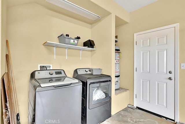 laundry room with washer and dryer and water heater