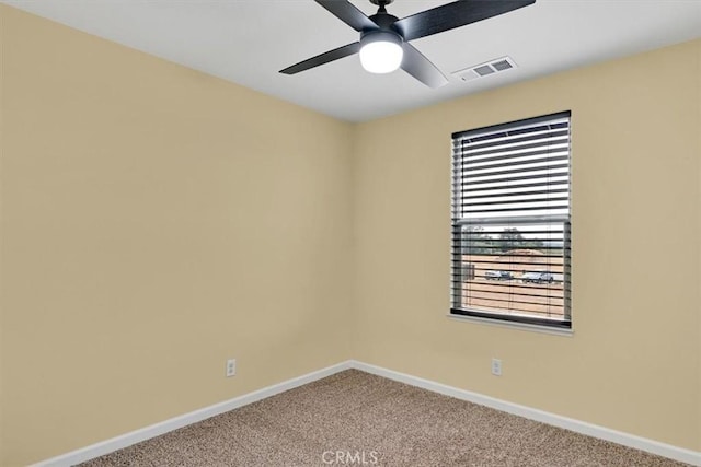 carpeted empty room with plenty of natural light and ceiling fan