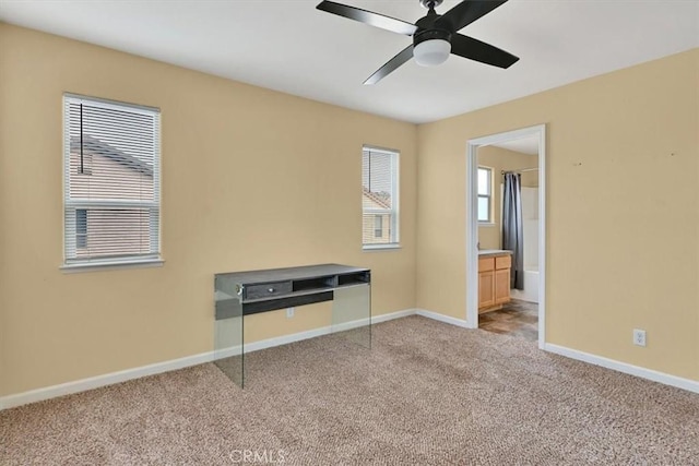 unfurnished bedroom with light carpet, connected bathroom, and ceiling fan