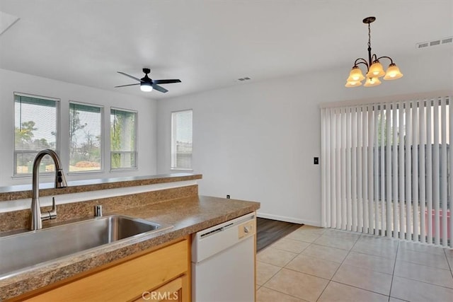 kitchen with ceiling fan with notable chandelier, sink, decorative light fixtures, dishwasher, and light tile patterned flooring