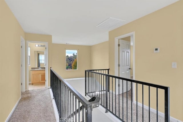 hallway featuring light carpet