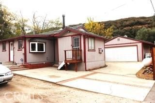 view of front facade with a garage and an outbuilding