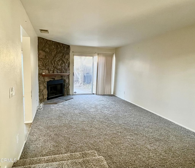 unfurnished living room featuring carpet flooring and a fireplace