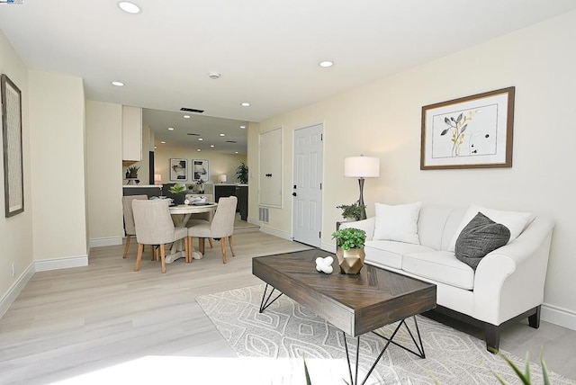 living room with light hardwood / wood-style flooring