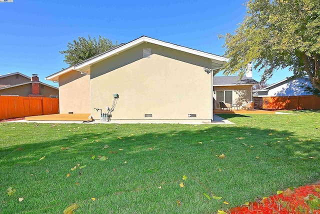 back of house featuring a yard and a patio area