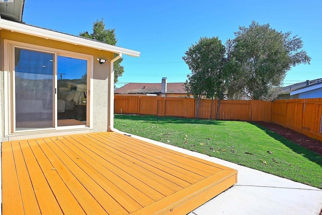 wooden deck featuring a yard