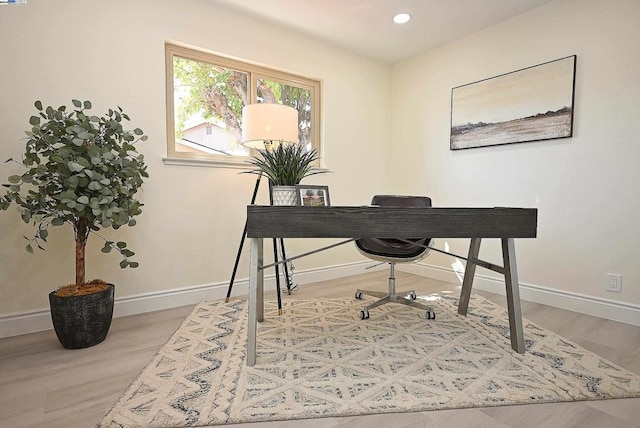 home office with wood-type flooring