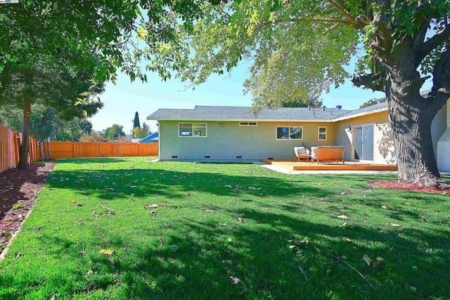 back of property with a patio and a yard