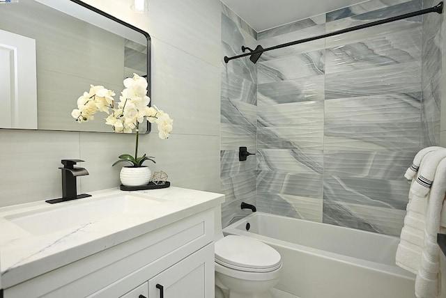 full bathroom featuring toilet, vanity, and tiled shower / bath