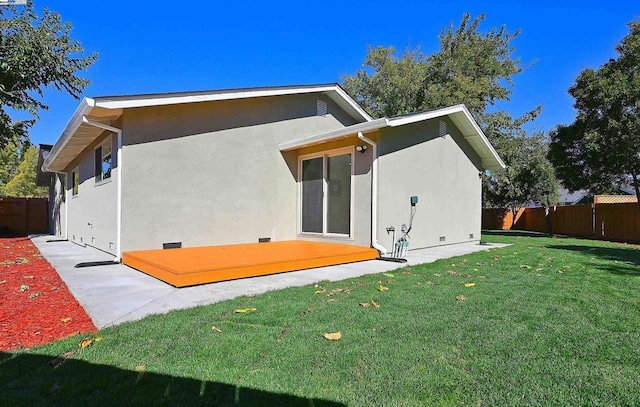 rear view of property with a yard