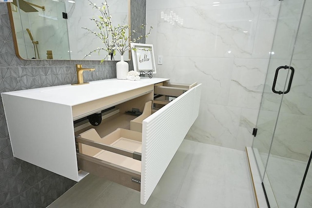 bathroom featuring walk in shower and vanity