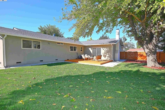 rear view of property featuring a patio and a lawn