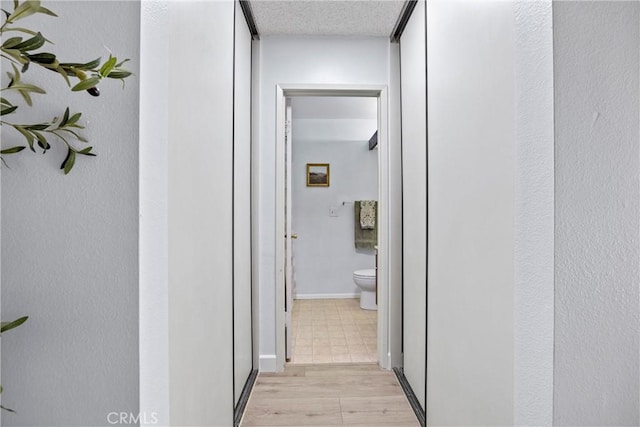 hallway with light wood-type flooring