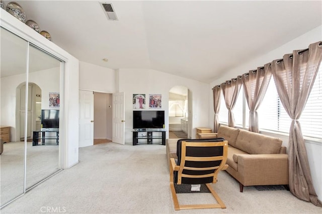 living room with light colored carpet and lofted ceiling