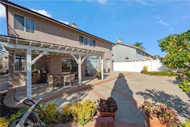 rear view of property with a pergola and a patio