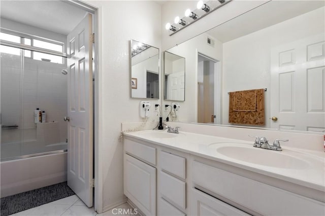 bathroom with tile patterned flooring, vanity, and enclosed tub / shower combo