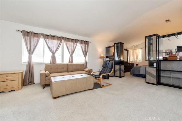 carpeted living room featuring vaulted ceiling