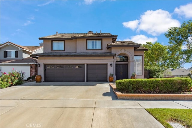 mediterranean / spanish-style home featuring a garage