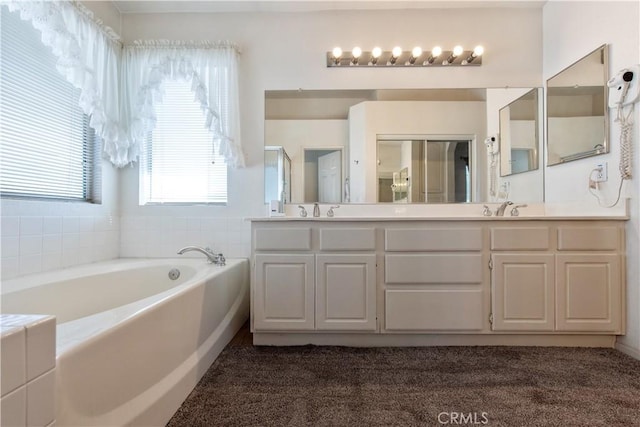 bathroom with vanity and independent shower and bath