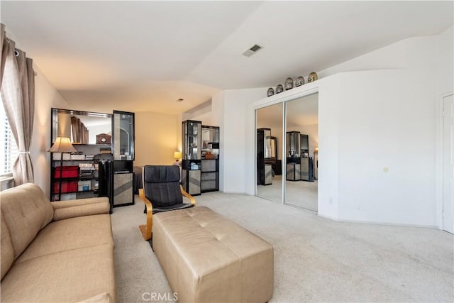 living room with light colored carpet and vaulted ceiling