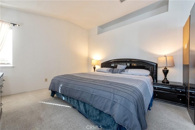 carpeted bedroom with vaulted ceiling