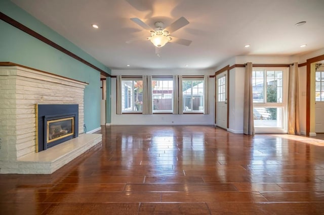 unfurnished living room featuring ceiling fan and dark hardwood / wood-style flooring