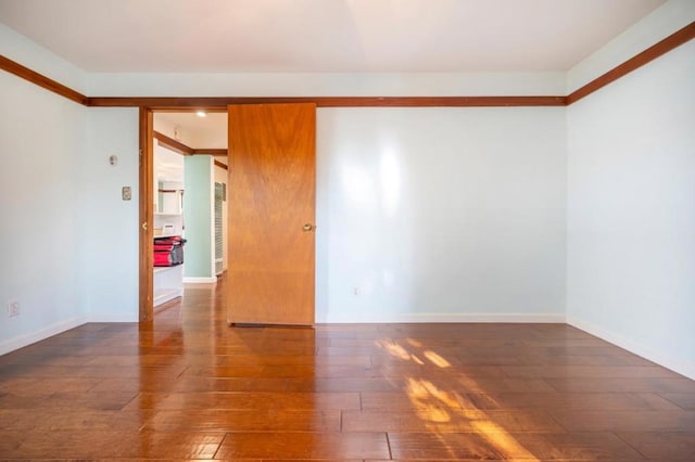 spare room featuring dark hardwood / wood-style floors