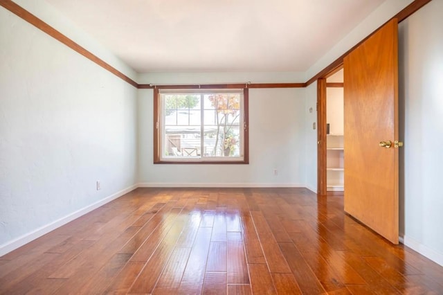 unfurnished room with wood-type flooring