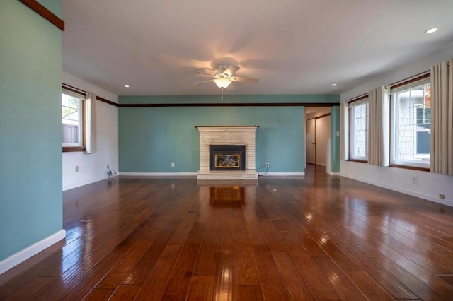 unfurnished living room featuring ceiling fan and dark hardwood / wood-style floors