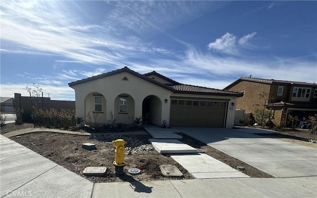 mediterranean / spanish home with a garage