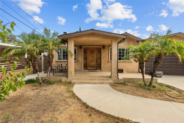 view of front of property featuring covered porch and a garage