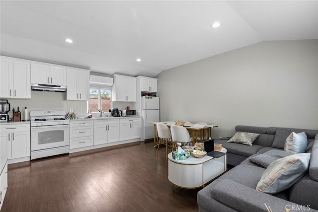 living room featuring vaulted ceiling, dark wood-type flooring, and sink