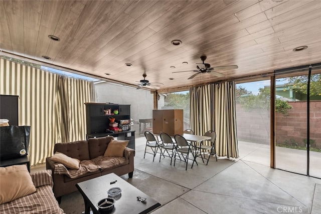 living room with ceiling fan, expansive windows, and wood ceiling