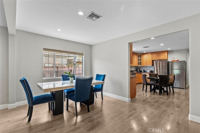 dining room with light hardwood / wood-style flooring