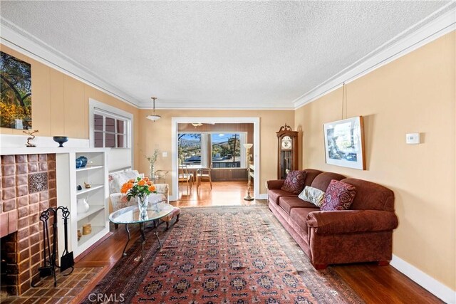 living room with a textured ceiling, crown molding, and dark hardwood / wood-style floors