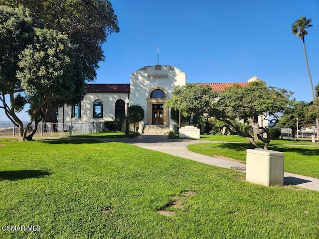 mediterranean / spanish-style house featuring a front lawn