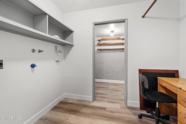 home office with light hardwood / wood-style flooring