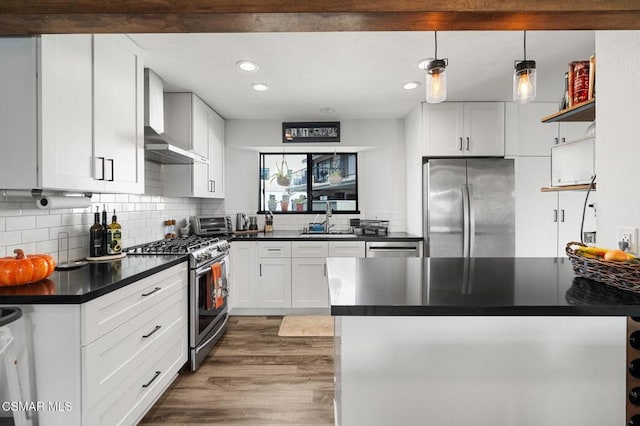 kitchen with dark hardwood / wood-style floors, sink, white cabinetry, and stainless steel appliances