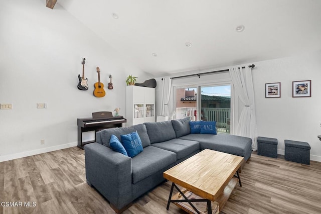 living room with vaulted ceiling and light wood-type flooring